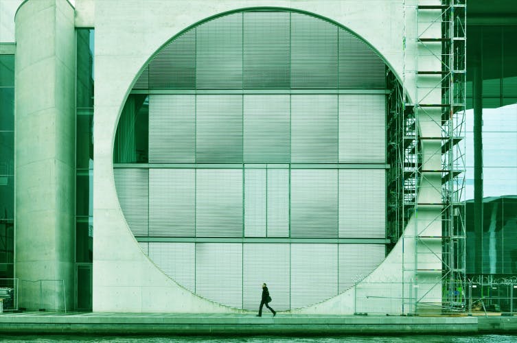 architectural composition with circle and walking man green filter