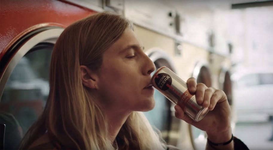 Person enjoys can of Azera coffee