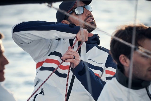 Henri Lloyd model wearing sailing jacket on boat