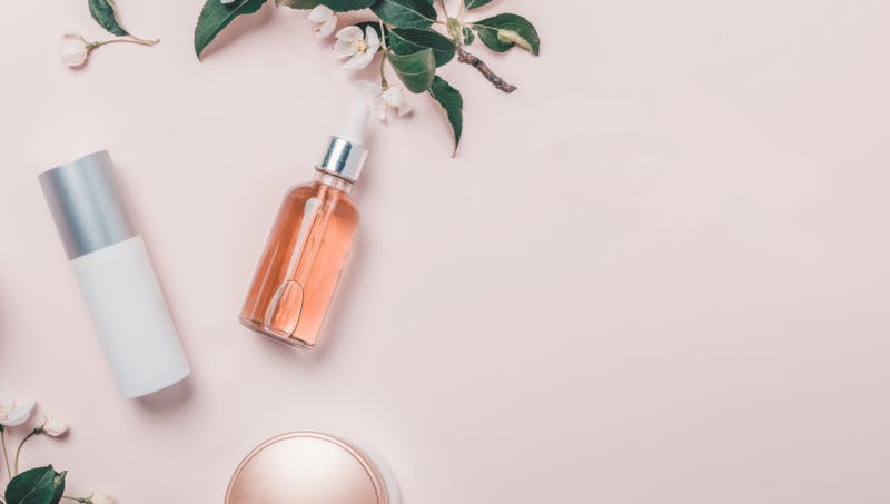 lancome bottles and plant on powder pink background