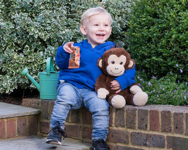 Child with Organix snacks and toy