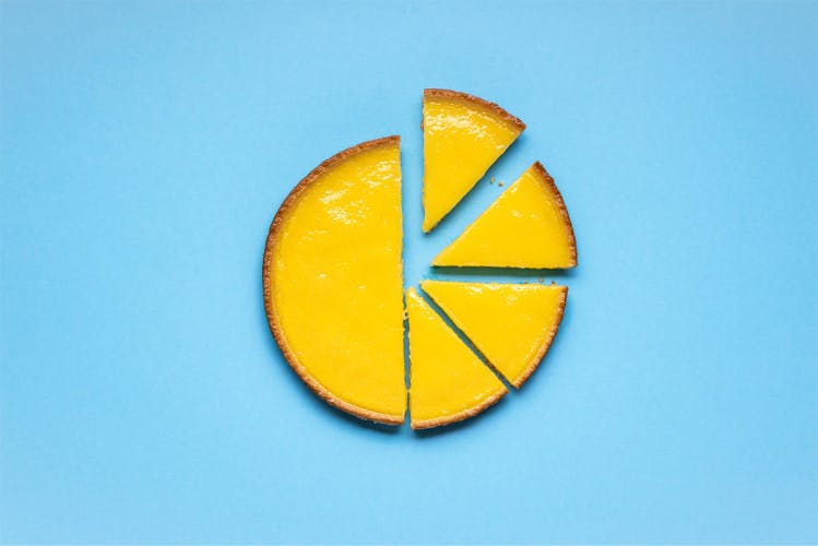 Lemon pie sliced on a blue background