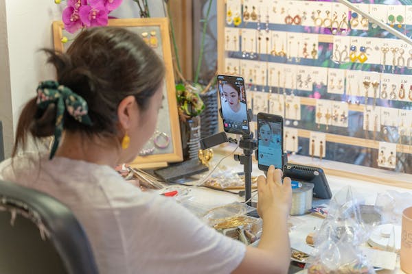 woman introduces her fashion jewelry mechandise. Editorial credit: helloabc / Shutterstock.com