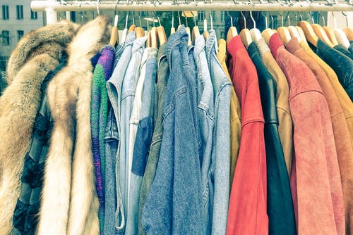 rack of vintage clothes. image via shutterstock
